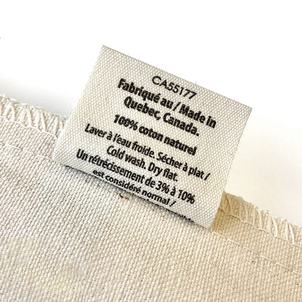 An Eco-friendly natural cotton bag attached to a white piece of cloth.
